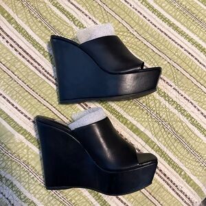 New, never worn black wedges.